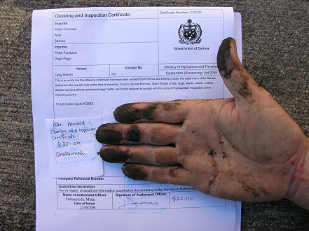 Quarantine certificate of a clean motorcycle, with dirt on my hand from the underneath