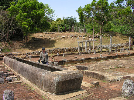 Ruins of a trough at Mihintale, filled with rice to feed monks