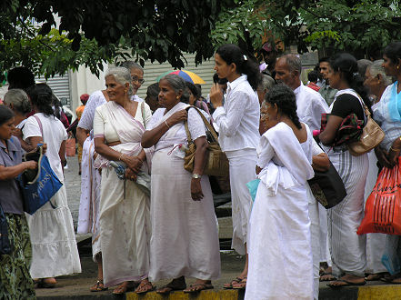 White dressed pilgrims visiting Sacred Tooth Temple Kandy