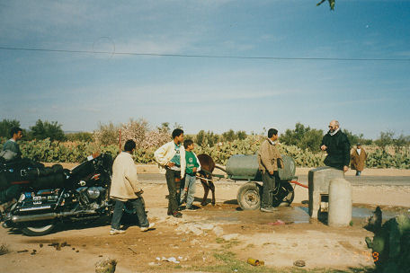 Locals collecting water with a donkey cart