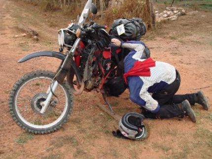 I became frustrated at having to get down and dirty at every gas stop.  I started to carry the tools I needed to do the bolt tightening in my tank bag instead of my stored tool kit.  That decision had a downside when they rattled enough against one of my cameras to crack the lens, making a near dark day foul-mood black. (Photo by Barry Prom).
