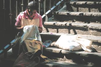 Indian woman embroidering.