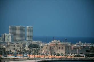 Tripoli, old town to right and 'coke bottle' office buildings on left.