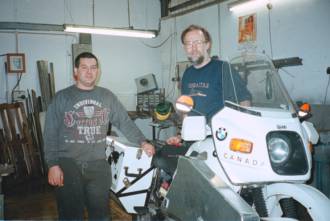 Grant and Mike with the bike and its new boxes in Gibraltar.