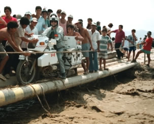 Grant and helpers on pipe bridge, northern Peru.
