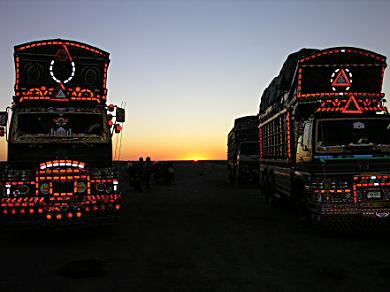 Sunrise leaving Taftan and brightly reflective trucks.