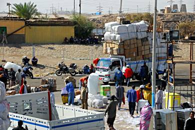 Waiting to load the ferry in Aswan for the trip to Wadi Halfa, Sudan. Another overloaded truck pulls up. Our motorcycles wait in the background.