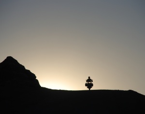 by Jolanta Glabek, of Brad Ryan, USA; On a sunset ride through Valle de la Luna, Chile, on our RTW tour; Africa Twin.