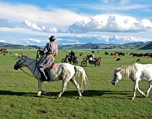 by Laurent Bendel, France; A Mongolian rider passes by and looks down upon Anders taking a break. Switzerland to Ladakh; Yamaha Ténéré.