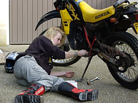 Charlotte working on her bike.