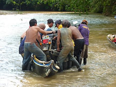 Getting the Harley into the canoe.