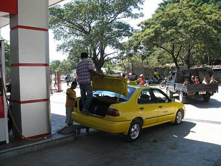 Filling gas tank.