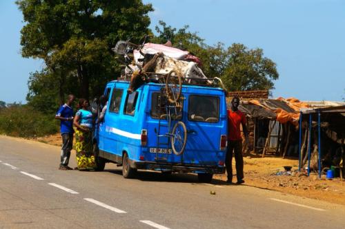 Cow on roof of van, Burkina Faso.