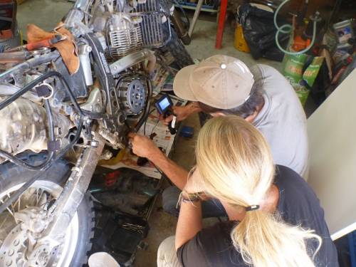 Examining the bike with a camera and a magnet.