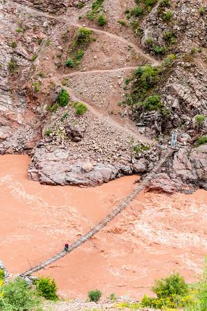 Adam Lewis crossing the Pamir River, Tajikistan.