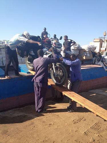 Unloading the bike in Sudan.