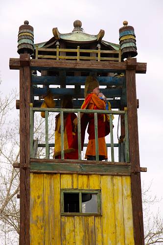 Monks blow on shell-horns to announce morning prayers, Ulaanbaatar, Mongolia.