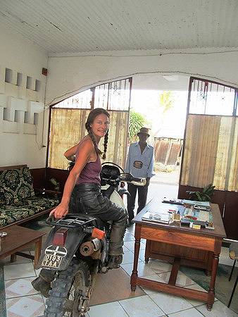 Tiffany Coates and bike in hotel reception, Madagascar.
