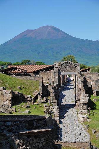 Pompeii entrance with Mount Vesuvius in the background.